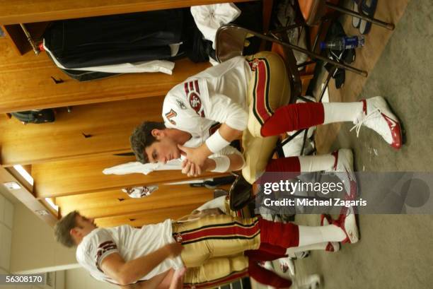 Quarterbacks Alex Smith and Ken Dorsey of the San Francisco 49ers prepare in the locker room before the game against the Tennessee Titans at the...