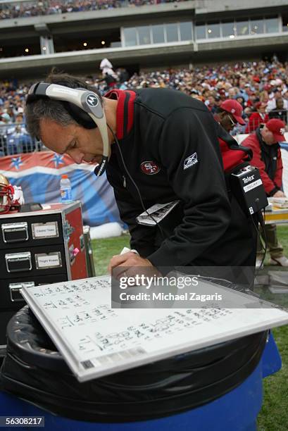 Head Coach Mike Nolan of the San Francisco 49ers reviews plays during the game against the Tennessee Titans at the Coliseum in Nashville, Tennessee...