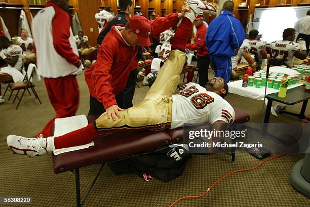 Linebacker Julian Peterson of the San Francisco 49ers stretches in the locker room at halftime during the game against the Tennessee Titans at the...