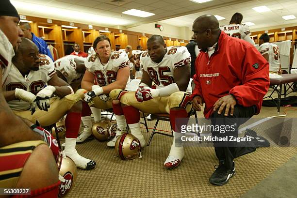 Defensive line coach Gary Emanuel meets with the defensive line of the San Francisco 49ers in the locker room at halftime during the game against the...