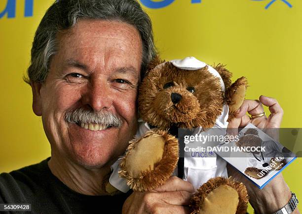 Artist and fashion designer Ken Done holds a UNICEF Teddy Bear aloft outside his Rocks Gallery as part of the world wide fundraiser for children on...