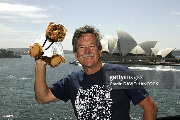 Artist and fashion designer Ken Done holds a UNICEF Teddy Bear aloft outside his Rocks Gallery as part of the world wide fundraiser for children on...