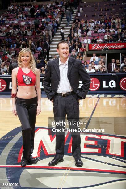Nascar driver Kurt Busch and a New Jersey Nets dancer at the game between the New Jersey Nets and the Detroit Pistons on November 30, 2005 at the...