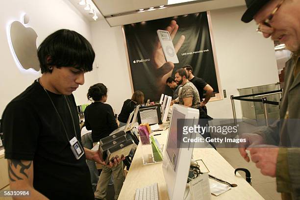 Customer purchases 3 Ipod Nanos at the Apple Store on November 16, 2005 in New York City.