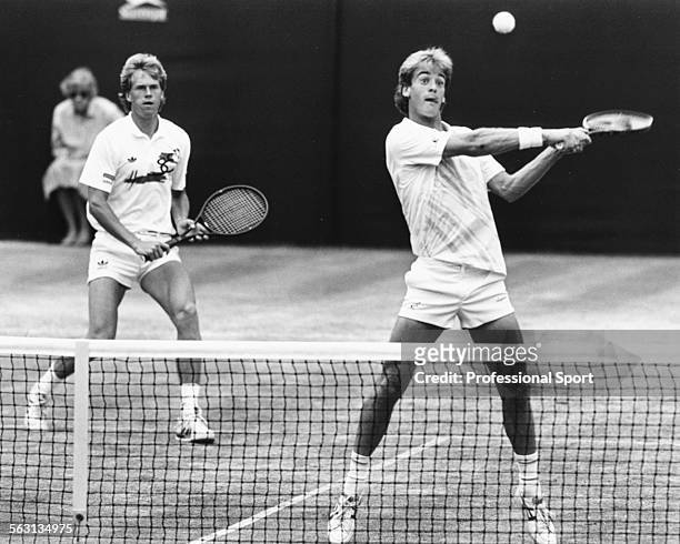 Swedish tennis players Stefan Edberg and Anders Jarryd in action in a Men's Doubles match on Centre Court at Wimbledon Tennis Championships in...