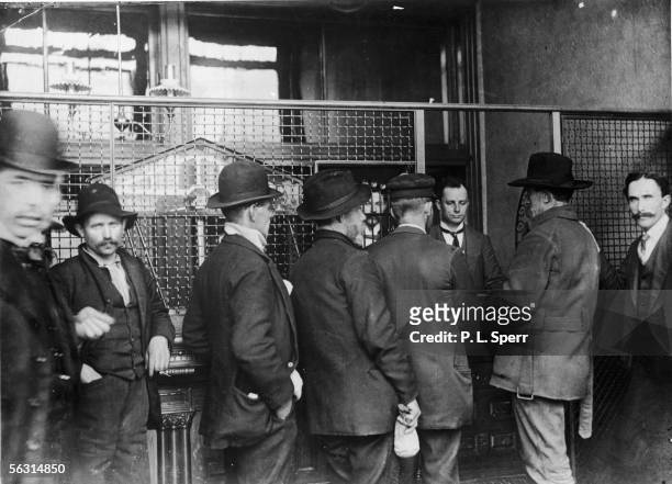 Gold prospectors line up outside the teller's window at the opening of the US Assay office in Seattle to make the first deposits from the Klondike...