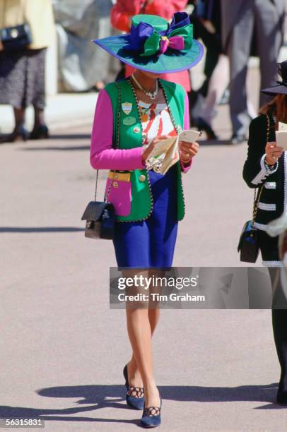 Racegoer attends Ladies Day at Ascot Races, Surrey, United Kingdom.