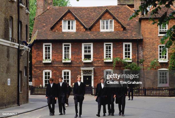 Eton schoolboys in traditional tailcoats at Eton College boarding school, Berkshire, UK.