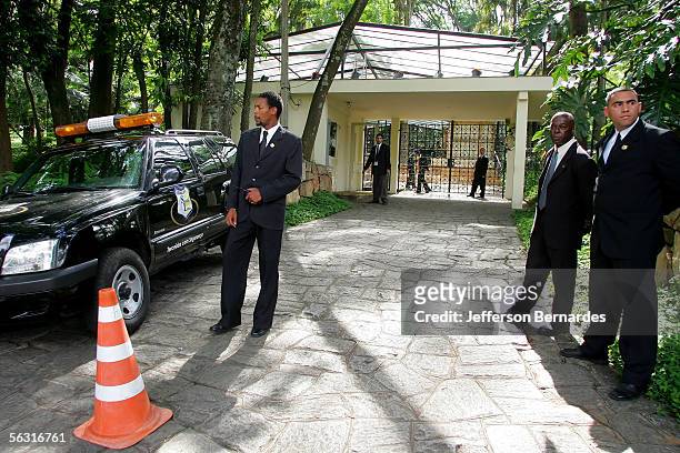 Security guards patrol outside of the grounds of the Maria Luisa and Oscar Americano Foundation as workers prepare the building for the wedding of...