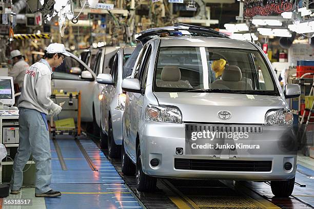 Employees of Toyota Motor Corporation work during the assembly process at the company's Takaoka Plant on December 2, 2005 in Toyota, Aichi...