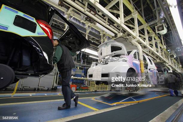 Employees of Toyota Motor Corporation work during the assembly process at the company's Takaoka Plant on December 2, 2005 in Toyota, Aichi...