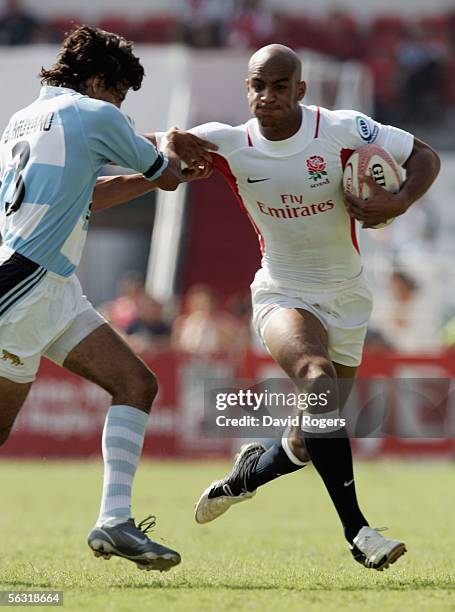 Tom Varndell of England holds off Martin Bustos Moyano of Argentina to score a try in the quarter final victory over Argentina during the Emirates...