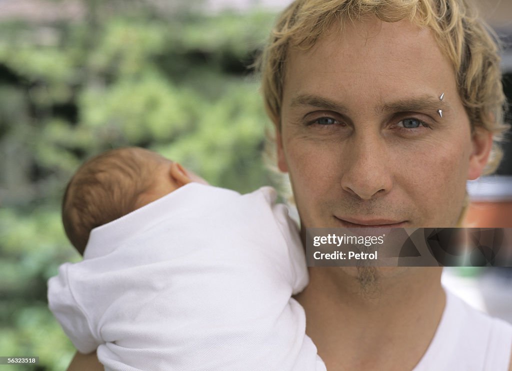 Young father holding his baby