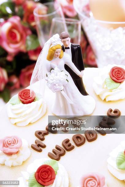 wedding cake topper with bride and groom - glass figurine stock pictures, royalty-free photos & images