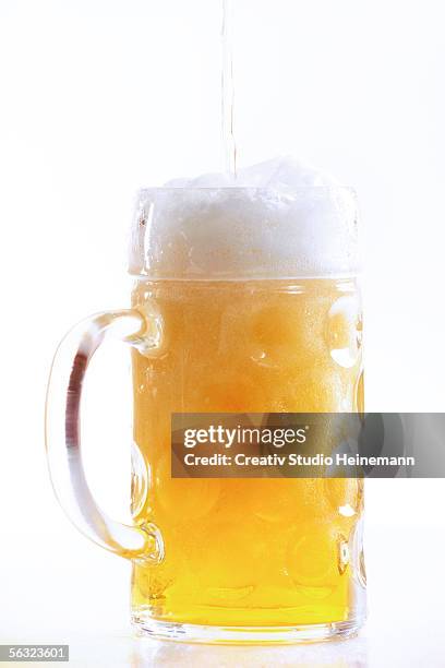 pouring beer into glass, close-up - stein stock pictures, royalty-free photos & images