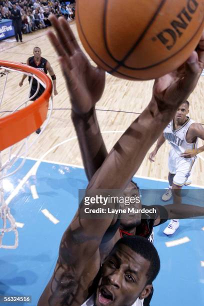 Desmond Mason of the New Orleans/Oklahoma City Hornets dunks the ball against Samuel Dalembert of the Philadelphia 76ers during a game at the Ford...