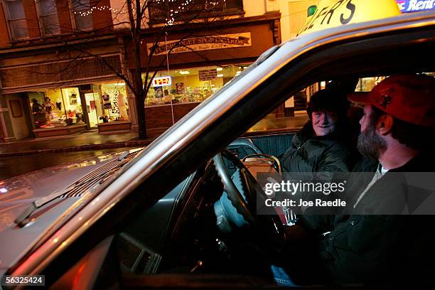 Vehicle drives past the window where Nikki Hunt and Tara Manns model lingerie in the front of Spellbound, a lingerie store, December 2, 2005 in...