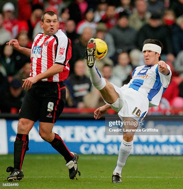 Richard Wood of Wednesday clears from Neil Shipperley of United during the Coca Cola Championship match between Sheffield United and Sheffield...