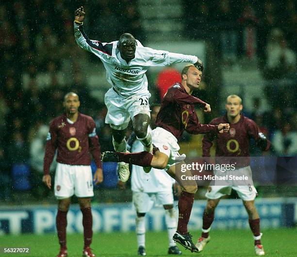 Abdoulaye Faye of Bolton clears from Dennis Bergkamp during the Barclays Premiership match between Bolton Wanderers and Arsenal at the Reebok Stadium...