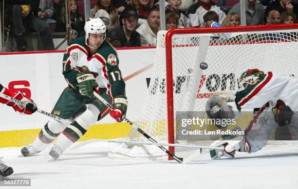 Manny Fernandez and Filip Kuba of the Minnesota Wild make a late third period save during a game against the New Jersey Devils at the Continental...