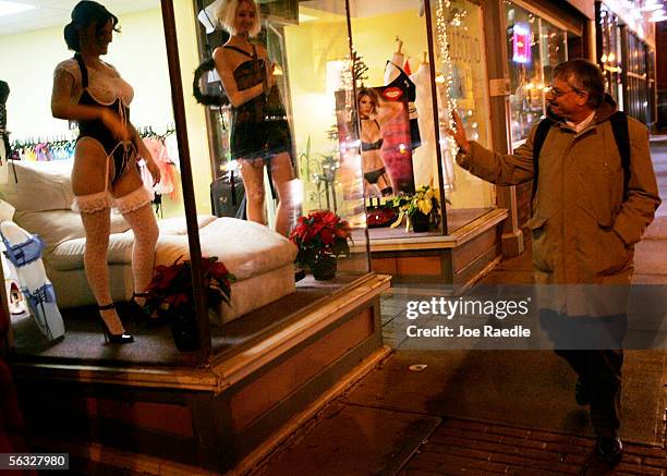 Nikki Hunt and Tara Manns model their lingerie in the store front window of Spellbound, a lingerie store, December 2, 2005 in Augusta, Maine....