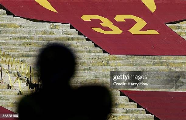 Silhouette of Reggie Bush of the USC Trojans is seen in front of the retired jersey of USC alumnus O.J. Simpson against the UCLA Bruins December 3,...