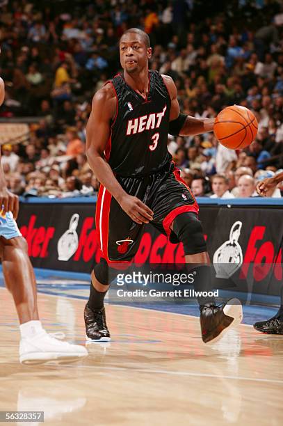Dwyane Wade of the Miami Heat goes to the basket against the Denver Nuggets on December 3, 2005 at the Pepsi Center in Denver, Colorado. NOTE TO...