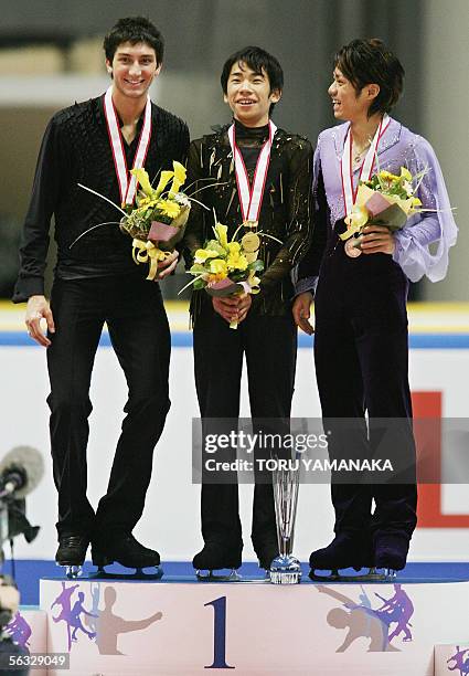 Winning Japanese skater Nobunari Oda shares a laugh with his compatriot third-placed Daisuke Takahashi when second-placed Evan Lysacek of the US...