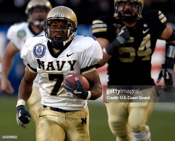 In this handout provided by the U.S. Coast Guard, running back Reggie Campbell of the Navy Midshipmen runs for a touchdown during the 106th Army v...