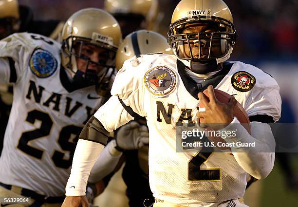 In this handout provided by the U.S. Coast Guard, quarterback Lamar Owens of the Navy Midshipmen runs for a touchdown during the 106th Army v Navy...