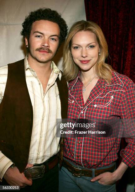 Actors Danny Masterson and Laura Prepon pose backstage during the Church of Scientology's "An Evening of Holiday Joy" benefiting the Hollywood Police...