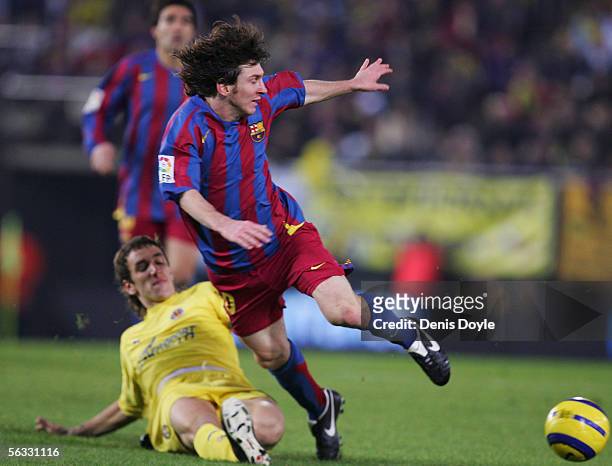 Lionel Messi of Barcelona is tackled by Gonzalo Rodriguez of Villarreal during the Primera Liga match between Villarreal and F.C. Barcelona on...