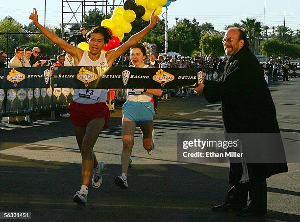 Adriana Fernandez of Mexico wins first place among women runners just ahead of second-place finisher Galina Bogomolva of Russia at the inaugural...