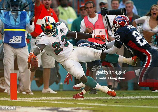 Running back Ronnie Brown of the Miami Dolphins lunges for the end-zone after catching touchdown pass from quarterback Sage Rosenfels in the fourth...