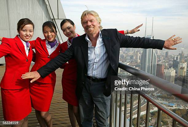 Richard Branson , chairman and founder of the Virgin Group of companies, poses for pictures with his employees during a press conference on December...