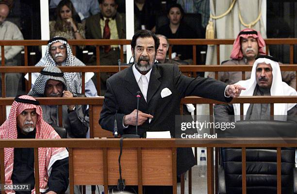 Former Iraqi President Saddam Hussein addresses the court as Awad Hamed al-Bander , Taha Yassin Ramadan , Abdullah Kadhem Ruaid , Mizher Abdullah...