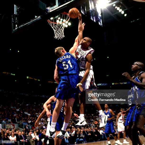 Vince Carter of the Toronto Raptors drives to the basket for a slam dunk against the Orlando Magic during an NBA game on April 19, 1999 at Air Canada...