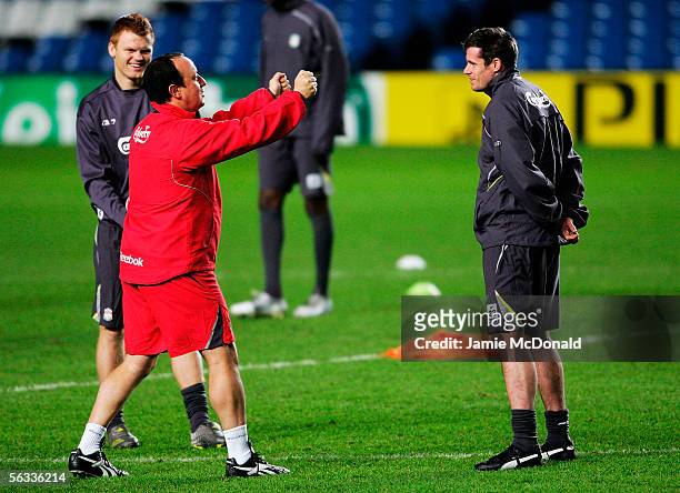 Manager Rafael Benitez speaks to John Arne Riise and Jamie Carragher during the Liverpool Football Club press conference and training session ahead...