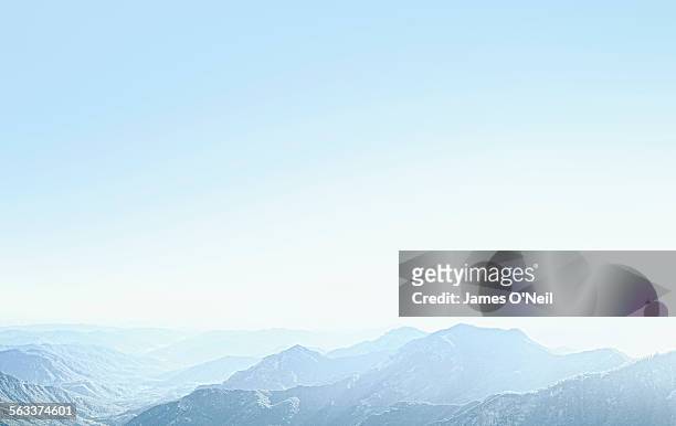 mountains with a sky blue haze - cielo azul fotografías e imágenes de stock