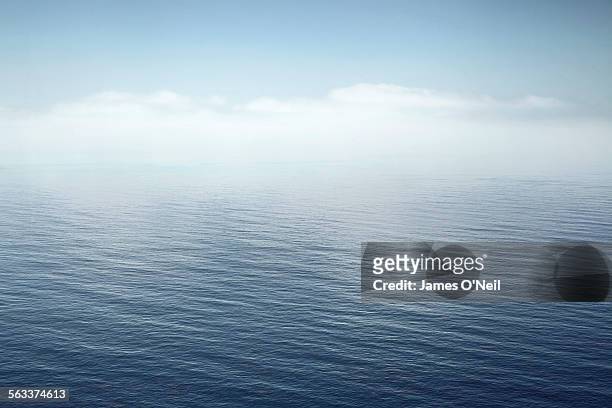 a calm sea fading into the sky - vista marina fotografías e imágenes de stock