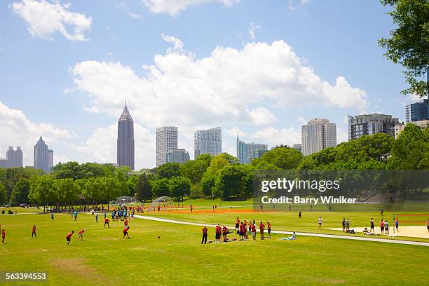 people in park playing kickbball, atlanta - kickball stock pictures, royalty-free photos & images