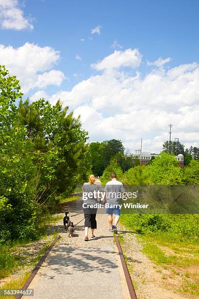 people walking dog on atlanta beltline - the beltline atlanta georgia stock pictures, royalty-free photos & images