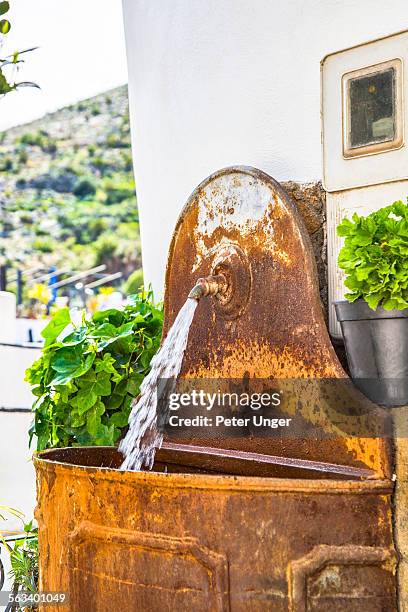 decorated water fountain and pot plants in street - merida spain stock pictures, royalty-free photos & images