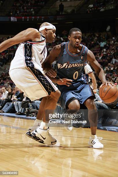 Gilbert Arenas of the Washington Wizards drives against Vince Carter of the New Jersey Nets during a game at Continental Airlines Arena on November...