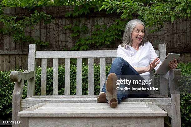 senior woman with tablet computer. - woman soles stockfoto's en -beelden