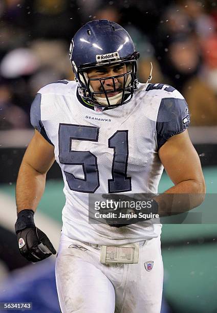 Lofa Tatupu of the Seattle Seahawks smiles as he runs off the field after scoring a touchdown in the second quarter of the game against the...