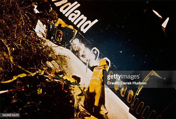 Firefighter at work the morning after the Kegworth air disaster, in which a Boeing 737-400, British Midland Flight 92, crashed onto the M1 near...