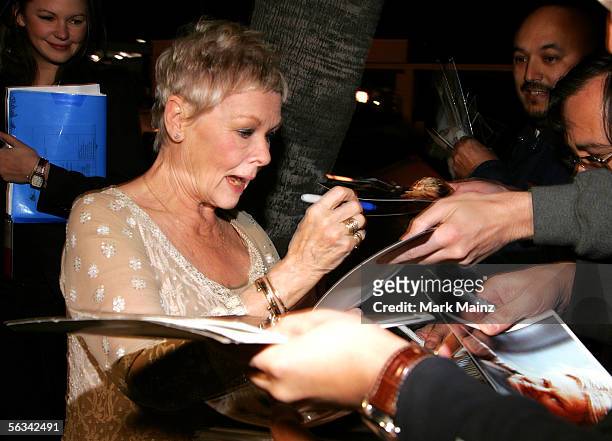 Actress Judi Dench signs autographs at the Los Angeles premiere of "Mrs. Henderson Presents" at the Fine Arts Theatre December 5, 2005 in Beverly...