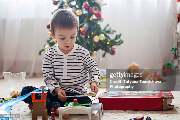 cute little boy, playing with toys at christmas - christmas toys stock pictures, royalty-free photos & images