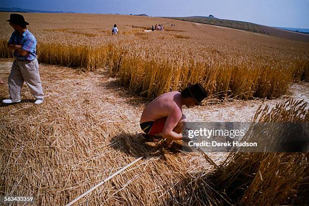 Researchers measuring crop circles in a field near Winchester, UK, 1990.